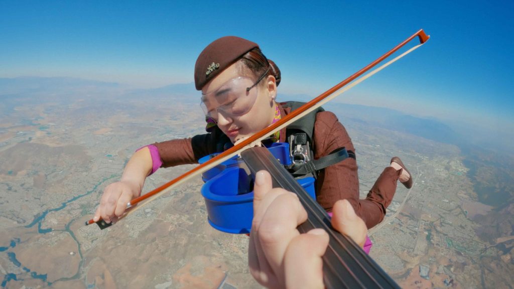 Skydiver violinist in the sky above Abu Dhabi. Image: Etihad Airways