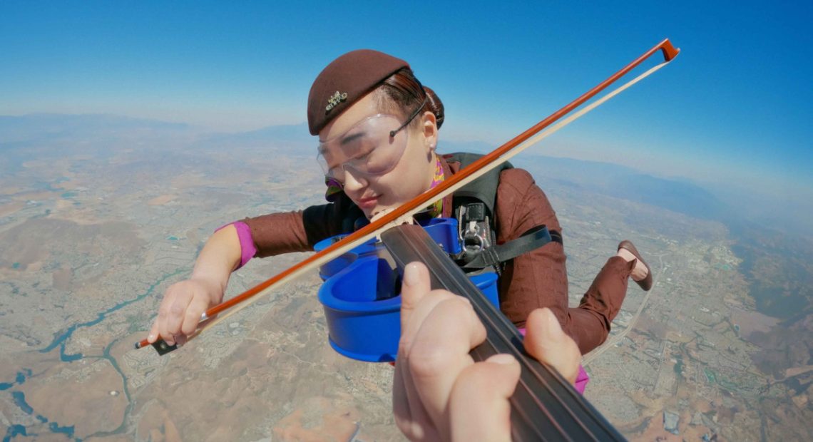 Skydiver violinist in the sky above Abu Dhabi. Image: Etihad Airways